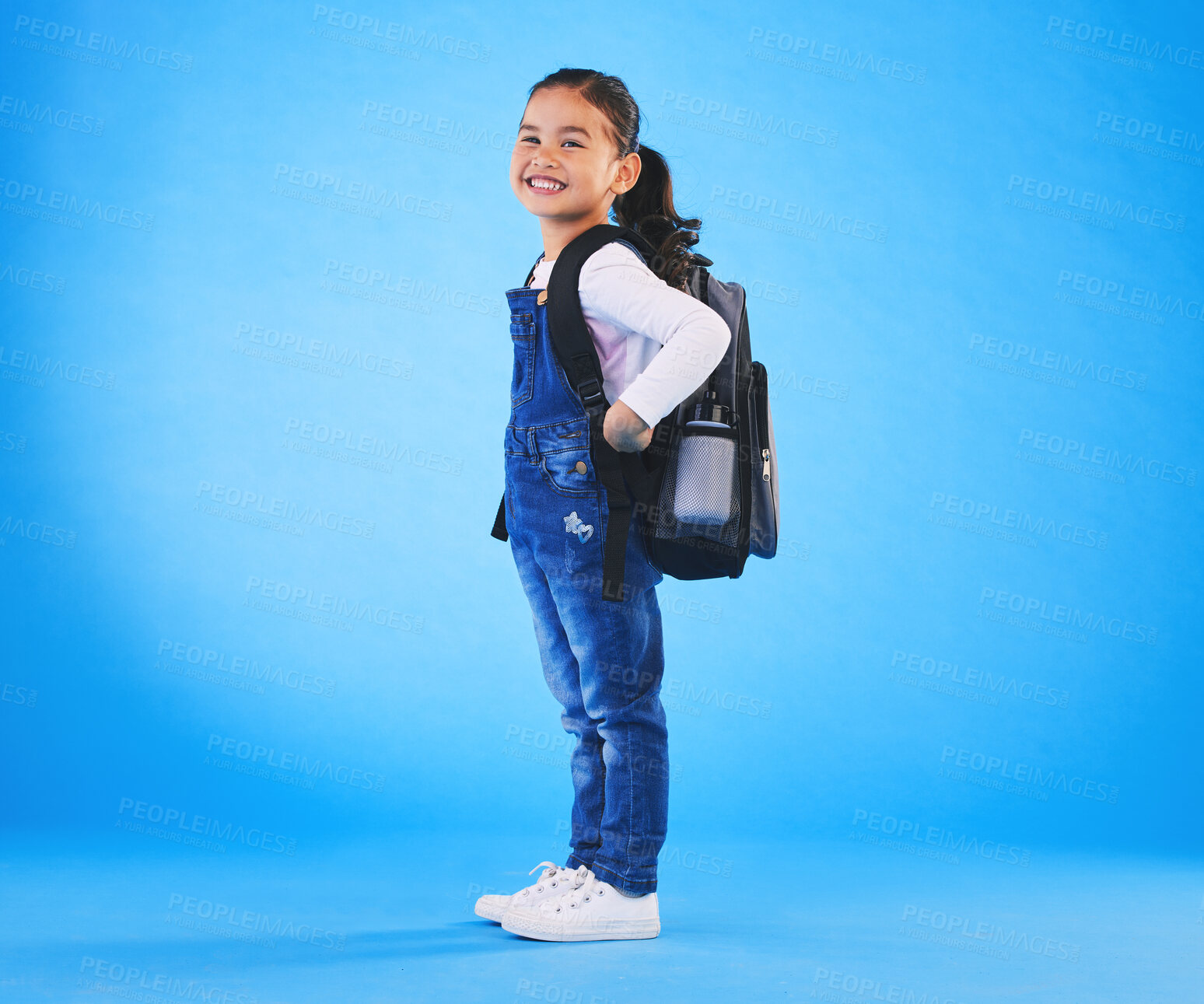 Buy stock photo School, backpack and portrait of child on blue background ready for class, learning and education. Student, happy and young girl with bag excited for lesson, academy and kindergarten in studio