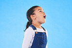 Shock, wow and girl child in a studio with mockup space for advertising, promotion or marketing. Surprise, wtf and full length of a kid model with omg face expression by blue background with mock up.