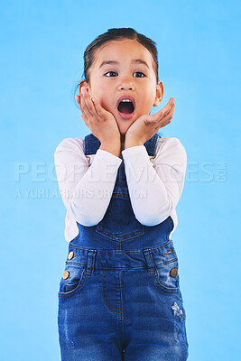 Buy stock photo Shocked, wow and girl with hands to face in studio with fear and scared from danger. Alarm, blue background and young child from Hawaii with scary, omg surprise and emoji face of a kid in danger