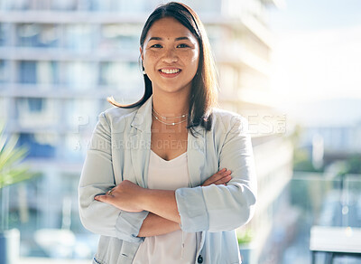 Buy stock photo Smile, crossed arms and portrait of a businesswoman in the office with confidence and happiness. Pride, career and face of a happy professional young Asian female lawyer standing in modern workplace.