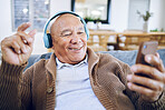 Phone, senior man and watch music video, streaming podcast and reading happy story, news article or retirement blog. Home, smartphone and elderly person with headphones, relax and listening to song