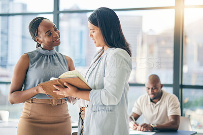 Buy stock photo Collaboration, diversity and notebook with business woman planning their schedule or calendar in the office. Teamwork, agenda and a professional employee reading a journal or diary with her colleague