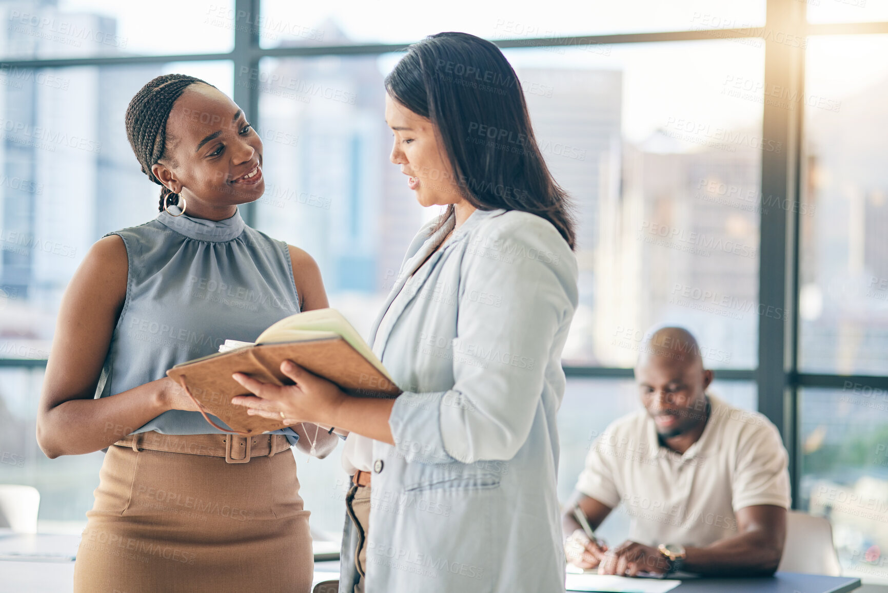 Buy stock photo Collaboration, diversity and notebook with business woman planning their schedule or calendar in the office. Teamwork, agenda and a professional employee reading a journal or diary with her colleague