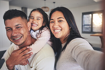 Buy stock photo Selfie, happy and portrait of a family with a smile bonding in the living room of their home. Together, love and young happy parents taking a picture with their sweet girl child for memories in house