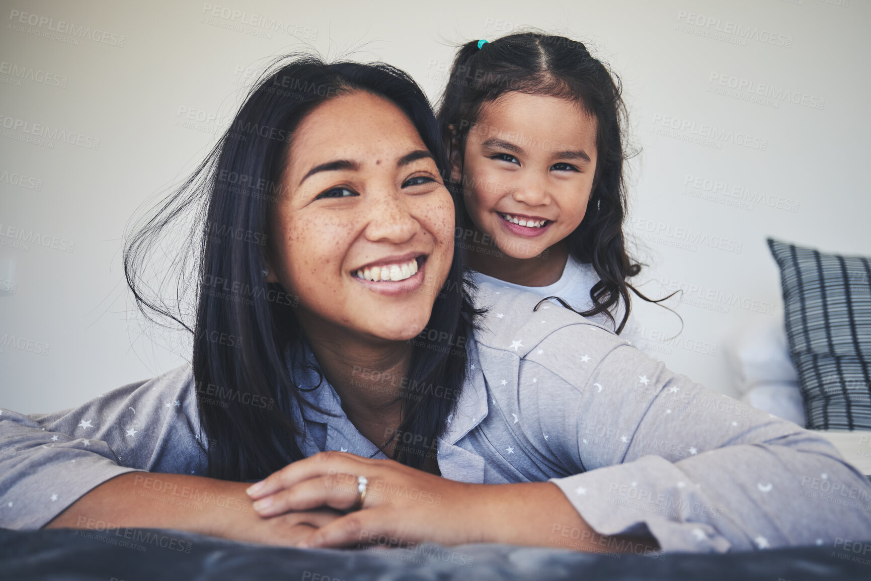 Buy stock photo Portrait, mother and daughter in bed at home with love, care and happiness in morning. A young woman and girl child together in a bedroom for fun time, playing and security or relax in a family house