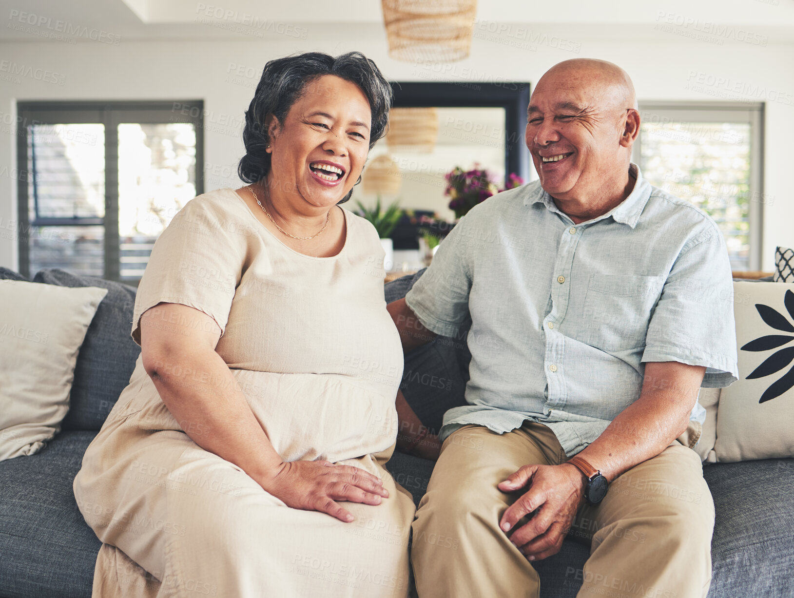 Buy stock photo Home, happy and senior couple on a couch, love and romance with retirement, funny and affection. Romantic, happy old woman and elderly man on a sofa, smile and bonding with care, marriage and support