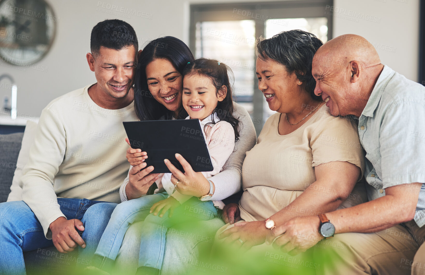 Buy stock photo Tablet, family and children on a sofa in the living room together during a visit with grandparents in retirement. Parents, senior people and kids using technology while browsing social media or games