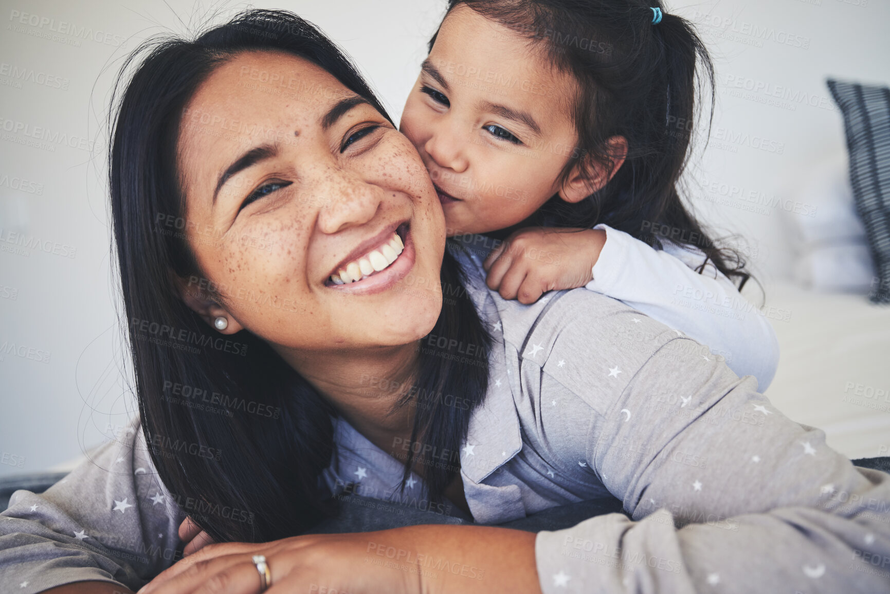 Buy stock photo Kiss, mother and daughter in bed at home with love, care and happiness in morning. Portrait of a woman and girl child together in a bedroom for fun time, playing and security or relax in family house