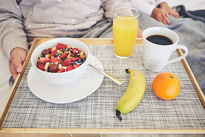 Buy stock photo Tray, hands and closeup of healthy breakfast in bed in the room of modern house on a weekend. Morning, diet and zoom of cereal with fruit, orange juice and cup of coffee for mother and child at home.