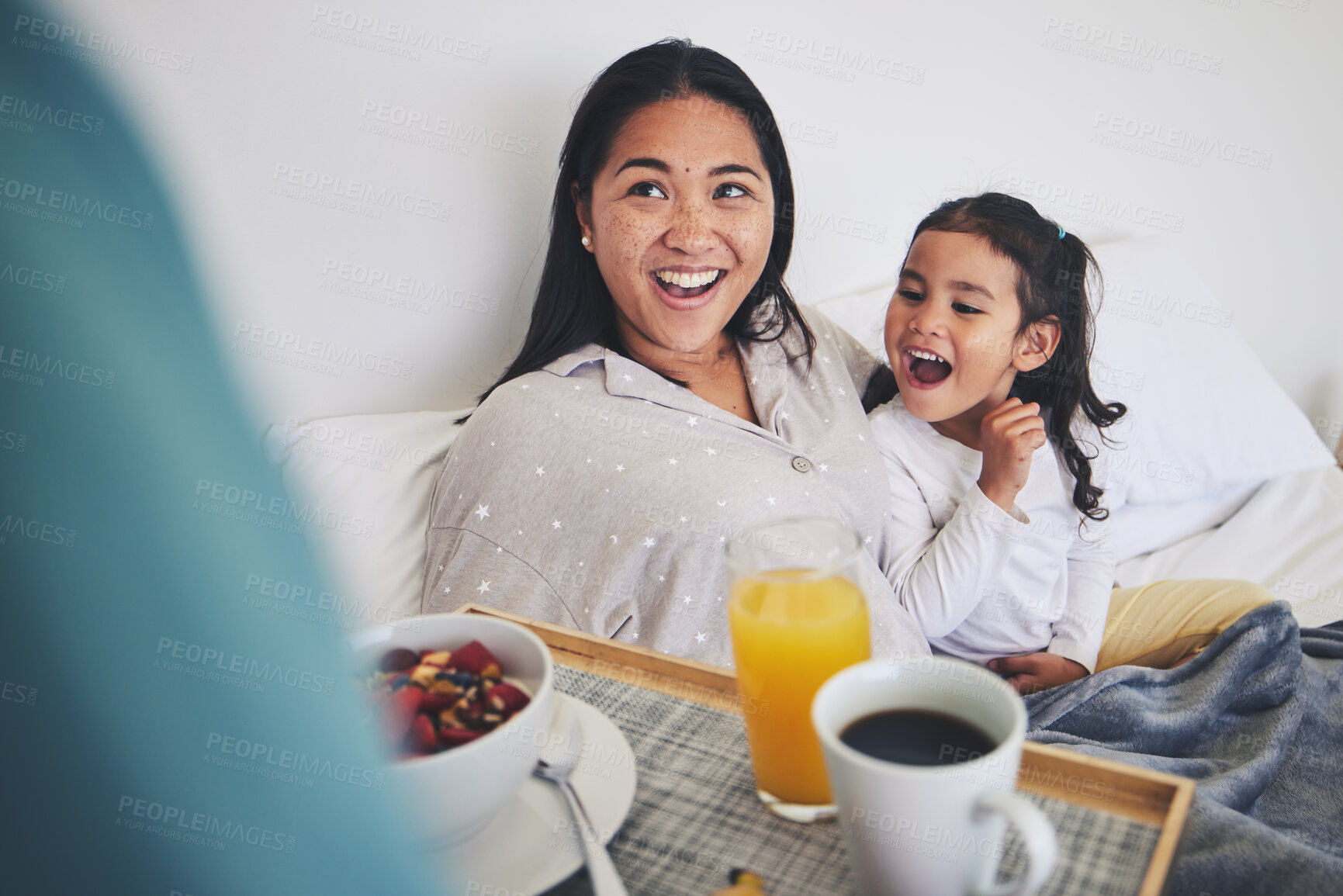 Buy stock photo Mother and child with breakfast in bed in the bedroom for mothers day surprise at home. Happy, smile and young mom relaxing with girl kid with a healthy meal for brunch on a weekend at their house.