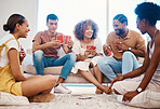 Game, laughing or friends playing cards, poker or black jack at home gambling together in a holiday party. Happy people, men or group of funny women relax in living room in a fun match competition