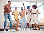 Singing, entertainment and friends dancing in living room with a microphone to music, playlist or radio. Happy, diversity and young people moving, bonding and having fun together with karaoke at home