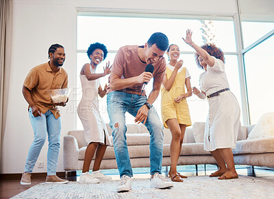 Buy stock photo Singing, party and friends dancing in the living room with a microphone to music, playlist or radio. Happy, diversity and young people moving, bonding and having fun together with karaoke at home.