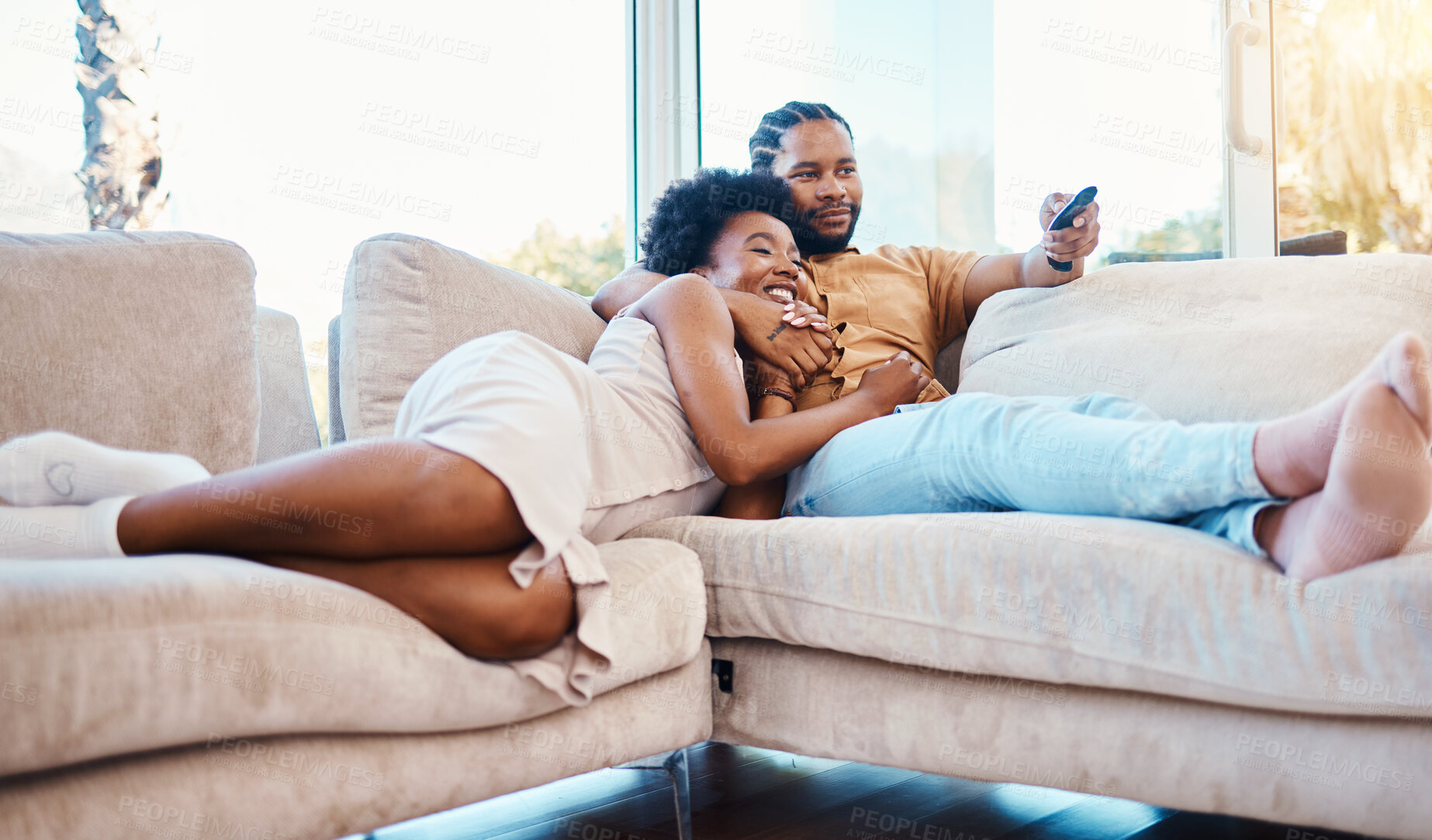 Buy stock photo Couple, watching tv and relax on home sofa together with love, care and happiness. African man and woman in a living room with a remote control for streaming movies, show or series on a couch