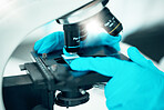 Microscope, medical science and research in a laboratory for analysis, study or development. Zoom on equipment for research, future and gloves of scientist person with virus, particle or dna sample