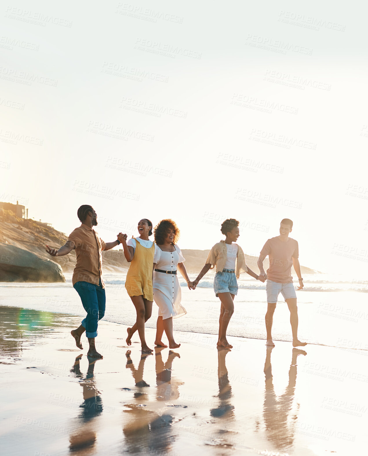 Buy stock photo Summer, holding hands and travel with friends at beach for freedom, support and sunset. Wellness, energy and happy with group of people walking by the sea for peace, adventure and vacation mockup