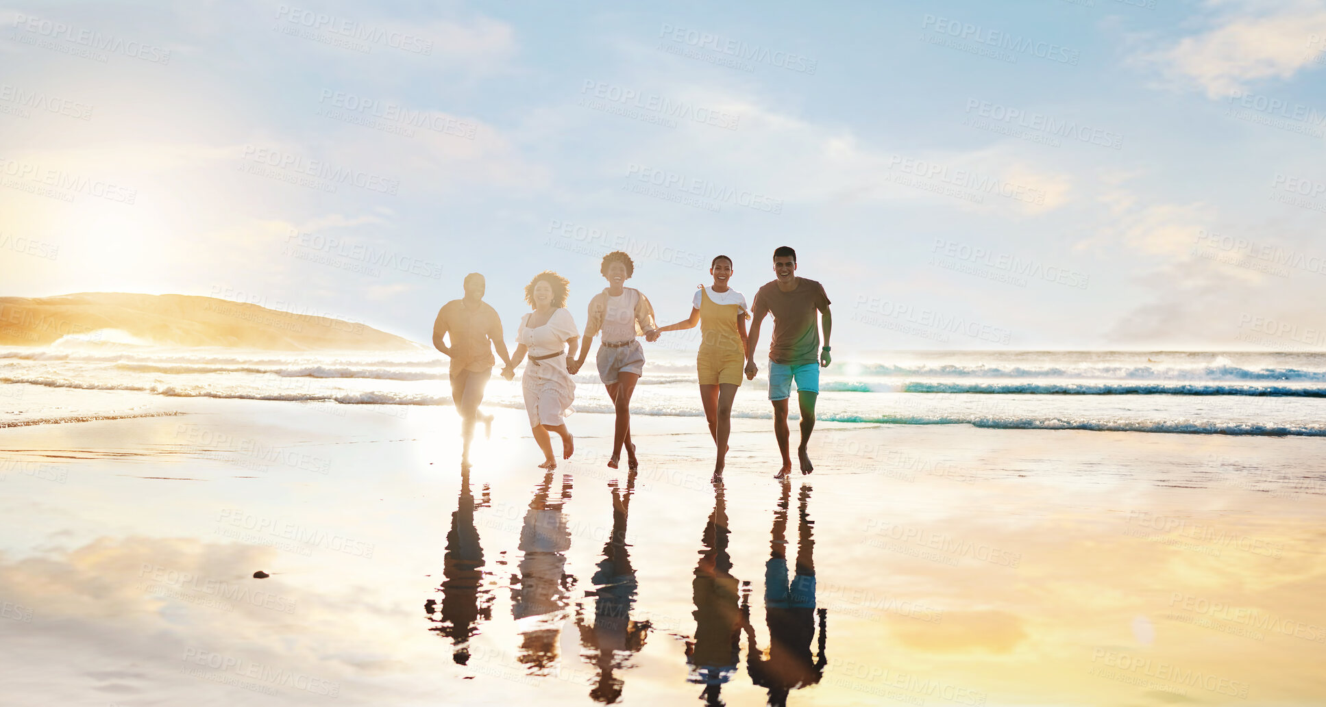 Buy stock photo Friends, together and walking on beach at sunset in water in summer, vacation or holiday break with freedom. Group, silhouette and people with connection, holding hands and support in community