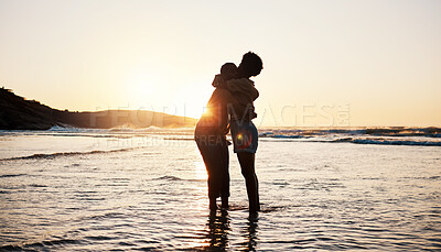 Buy stock photo Beach, sunset and silhouette of couple hug, connect and enjoy romantic time together, bonding and relax in sea water. Dark shadow, summer love or outdoor people embrace on tropical marriage honeymoon