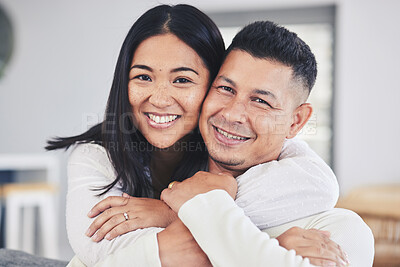 Buy stock photo Love, hug and portrait of a couple in the living room bonding together in their modern house. Happy, smile and face of young man and woman with affection while relaxing in the lounge at home.