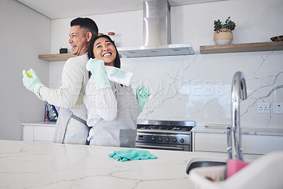 Buy stock photo Happy, love and couple cleaning in kitchen for hygiene, safety and prevention of bacteria at home. Spring clean, bond and man with woman smile for household, housework or  fun while sharing chores