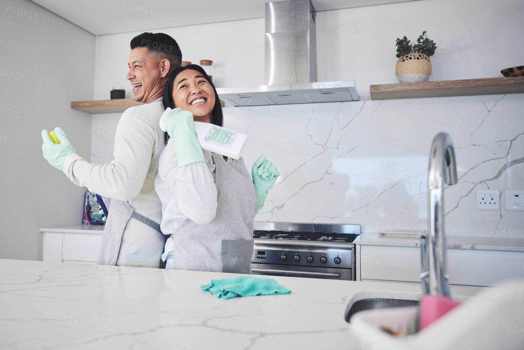 Buy stock photo Happy, love and couple cleaning in kitchen for hygiene, safety and prevention of bacteria at home. Spring clean, bond and man with woman smile for household, housework or  fun while sharing chores