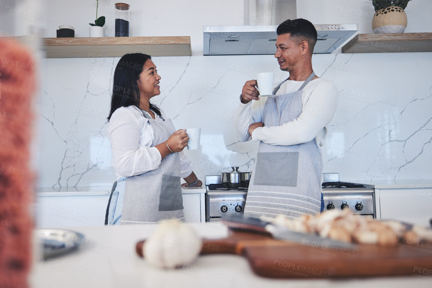 Buy stock photo Couple in kitchen, coffee and cooking together with conversation, smile and love in home. Relax, man and woman in bonding discussion, making food for dinner vegetables and drinking tea in apartment.