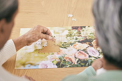 Buy stock photo Puzzle on table, entertainment and senior couple in home for bonding, fun activity and relax together. Retirement, marriage and above of man and woman with jigsaw for playing games, hobby and connect