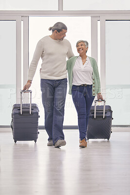 Buy stock photo Mature couple, luggage and walking in airport lobby, happy and travel together, tourist holiday and vacation. Man, woman smile and suitcase for flight, immigration journey and global airplane trip