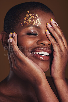 Buy stock photo Art, cosmetics and black woman with gold makeup on brown background, glitter paint and beauty. Shine, glow and African model in studio for fashion inspiration, aesthetic freedom and luxury skincare.