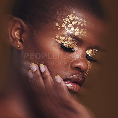 Buy stock photo Gold beauty, blur and black woman with hand on face closeup with makeup and cosmetics in studio. Brown background, African female model and manicure with golden shine and glow from paint sparkle