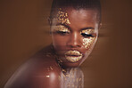 Gold beauty, luxury makeup and black woman with blur in studio with glitter cosmetics and sparkle art. Brown background, African female model and shine from paint and skin glow with golden treatment