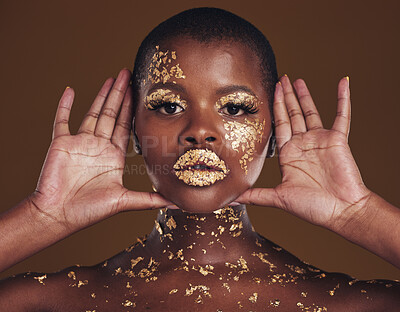 Buy stock photo Cosmetics, portrait and black woman with gold makeup on brown background with glitter paint. Shine, glow and African model in studio for beauty, fashion art and aesthetic freedom in luxury skincare.