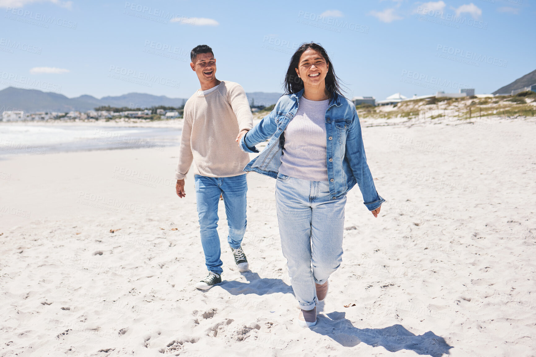 Buy stock photo Love, happy and holding hands with couple at beach for travel, summer vacation and romance together. Smile, relax and bonding with man and woman walking on seaside holiday for care, date or honeymoon