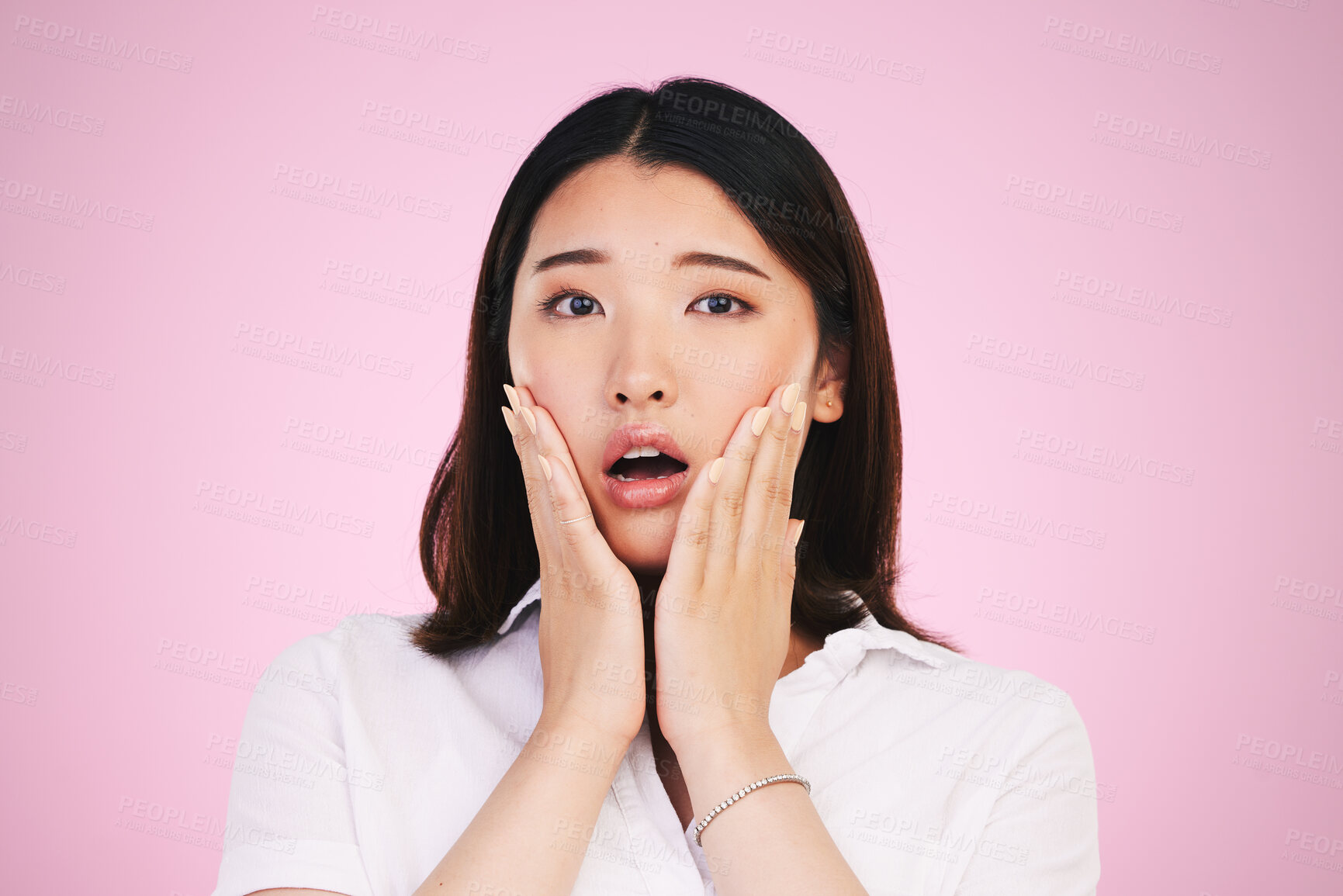 Buy stock photo Surprise, wow and hands on woman face in studio with anxiety for fake news, drama or secret on pink background. Omg, portrait and Japanese female model shocked by gossip, announcement or emoji info