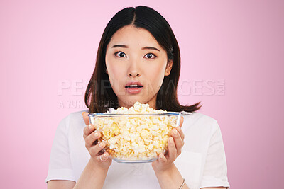 Buy stock photo Movie, popcorn and portrait of woman with surprise, horror and bowl or food for watching tv, movies with shock. Wow, face and scared Asian model on pink background in studio with film snack 