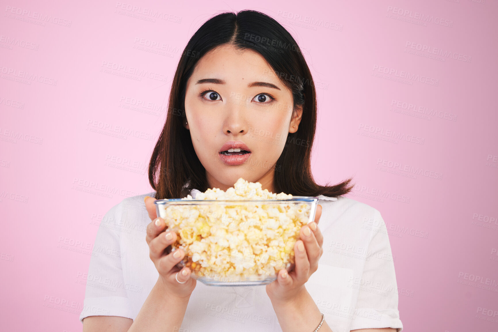 Buy stock photo Movie, popcorn and portrait of woman with surprise, horror and bowl or food for watching tv, movies with shock. Wow, face and scared Asian model on pink background in studio with film snack 