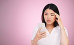 Space, phone and stress with face of woman in studio for networking, communication and worry. Social media, news and frustrated  with asian person on pink background for technology and mockup