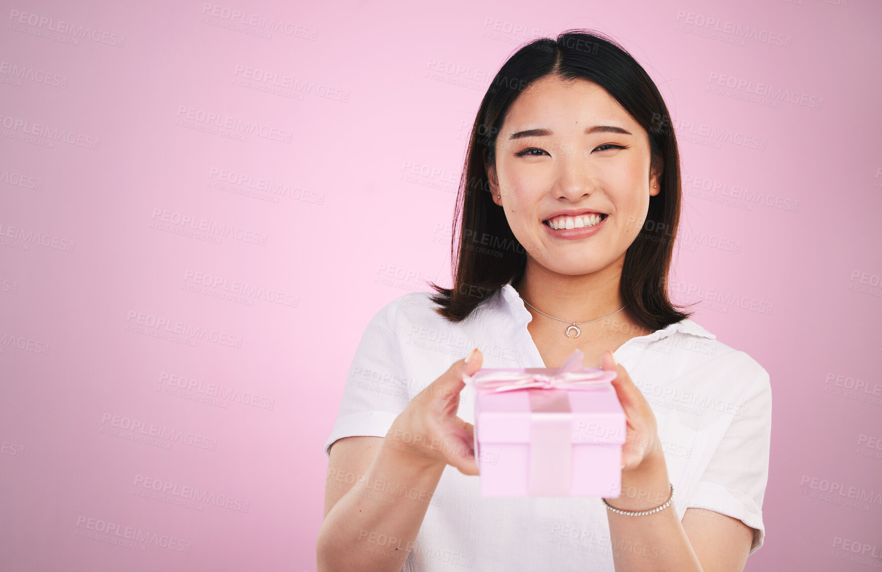 Buy stock photo Gift, Asian and portrait of woman giving present box happy for celebration isolated in a studio pink background. Giveaway, ribbon and person with happiness for surprise or prize package with smile