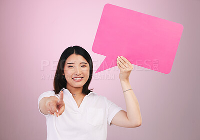 Buy stock photo Asian woman, speech bubble and pointing to you on mockup space in choice against a pink studio background. Portrait of female person shape, icon or symbol in decision, selection or vote on mock up