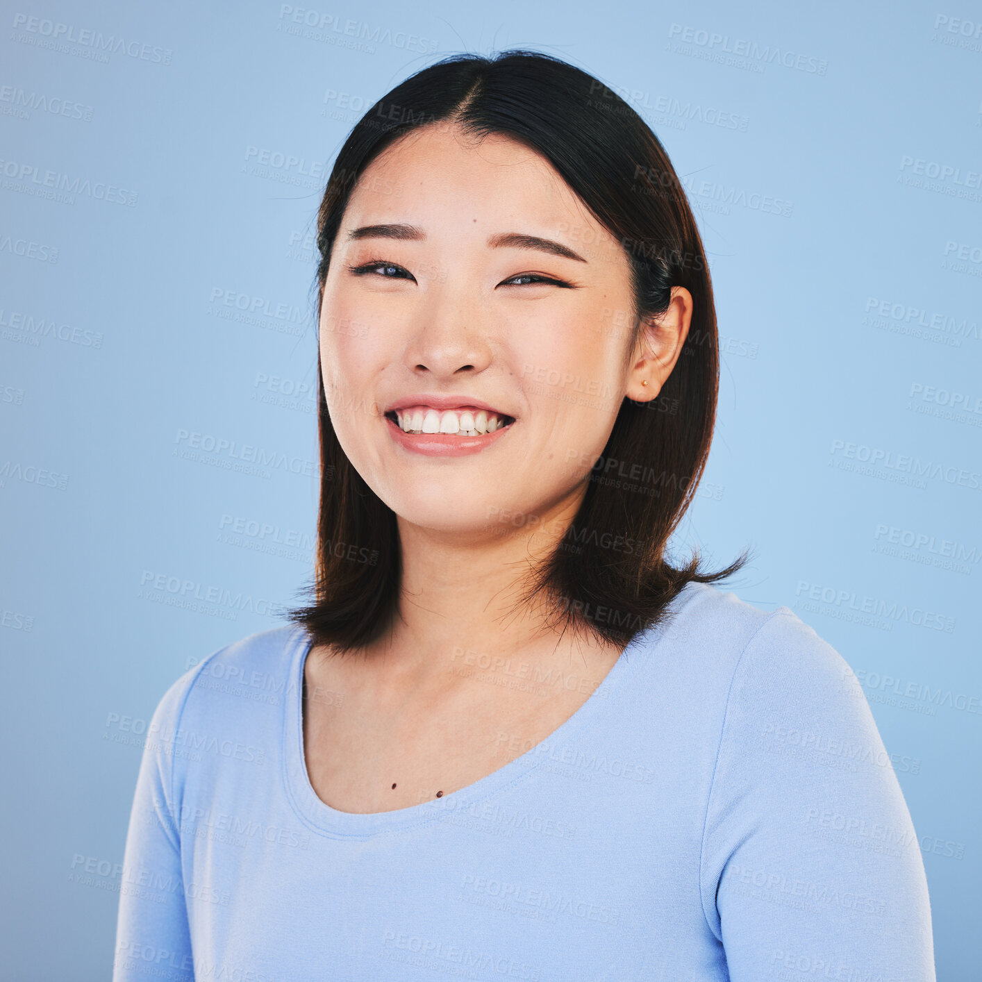 Buy stock photo Happy, smile and portrait of Asian woman in a studio with a natural, makeup and beauty face. Self care, cosmetics and headshot of a young female model with a cosmetology routine by a blue background.