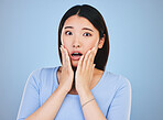Scared, portrait and Asian woman with fear from news, announcement or horror story on blue background in studio. Shock, face and person with wow, emoji or facial expression with stress or anxiety