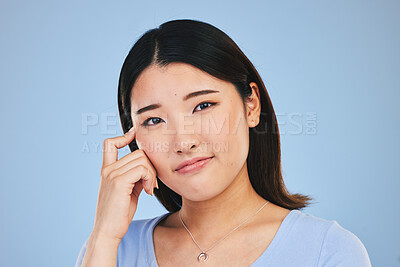 Buy stock photo Portrait, thinking and Asian woman with ideas, solution and problem solving on a blue studio background. Face, Japanese person and model with a question, emoji and mockup space with brainstorming