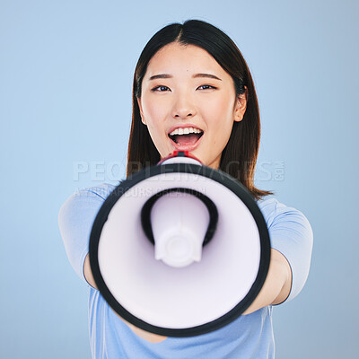 Buy stock photo Woman, megaphone and voice for announcement, broadcast or student news and sale on blue background. Young asian person in portrait for call to action, university attention or college speech in studio
