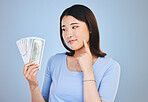 Woman, money and winner thinking of bonus offer, financial success and winning, finance loan or choice. Asian person or customer for cash, savings decision or profit ideas on blue, studio background