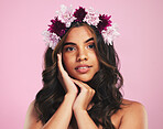 Woman, portrait and flower crown for beauty in studio with natural skincare, spring plants and pink background. Face, model and floral wreath for sustainable cosmetics, vegan dermatology or hair care