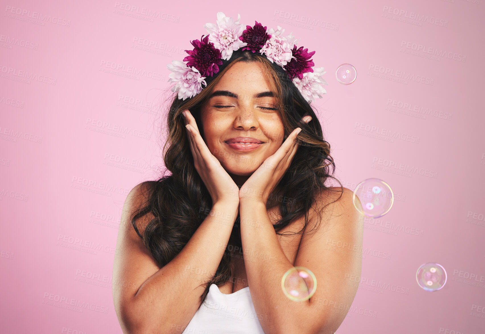 Buy stock photo Beauty, relax and bubbles with woman and flower crown in studio for cosmetics, skincare and wellness. Hair care, spa treatment and face with person on pink background for spring, glow and makeup 
