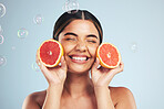 Smile, woman and grapefruit skincare in studio for natural, cosmetic or wellness on grey background. Beauty, happy and model face with citrus facial, fruit or vitamin c, collagen and bubble aesthetic