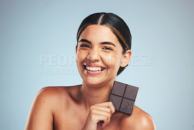 Buy stock photo Portrait, chocolate and happy woman in studio with diet, craving or unhealthy luxury snack on grey background. Face, smile and lady model with candy bar, sugar and cocoa, addiction or diet temptation