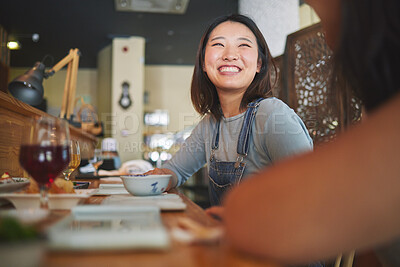 Buy stock photo Happy, eating and friends at a restaurant for food, conversation or bonding together. Smile, excited and an Asian girl or women at a cafe for fine dining, talking and hungry at a table with people