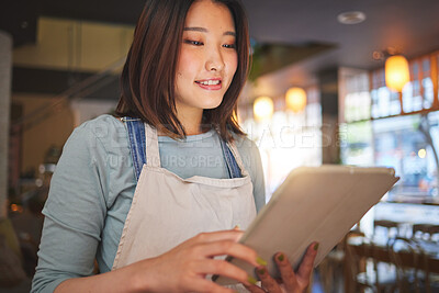 Buy stock photo Restaurant, tablet and Asian woman online for order for food service, inventory and check menu. Coffee shop, small business and happy waitress, barista or manager on digital tech for cafe website